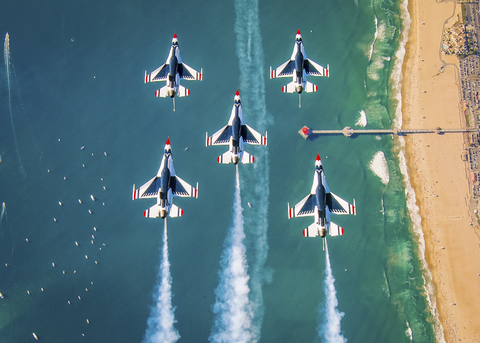 Pacific Airshow jets flying in formation over the Huntington Beach coastline